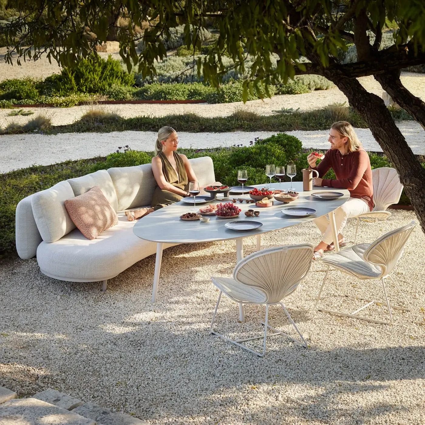 Superior Royal Botania Styletto lounge chair with a low profile and rounded seat in light beige textile with white metal legs