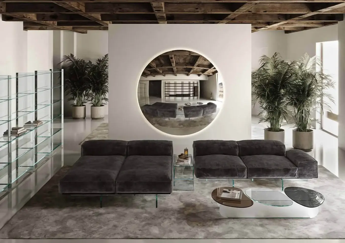 Gray modular sofa and iris mirror by Tonelli in modern living room with palm trees, wood beams, and concrete flooring.