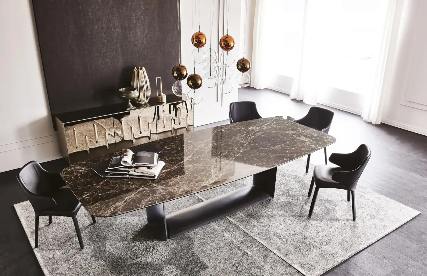 Cattelan Italia Dragon table, dark brown ceramic top, black metal base with shelf, surrounded by six black upholstered dining chairs on grey rug.