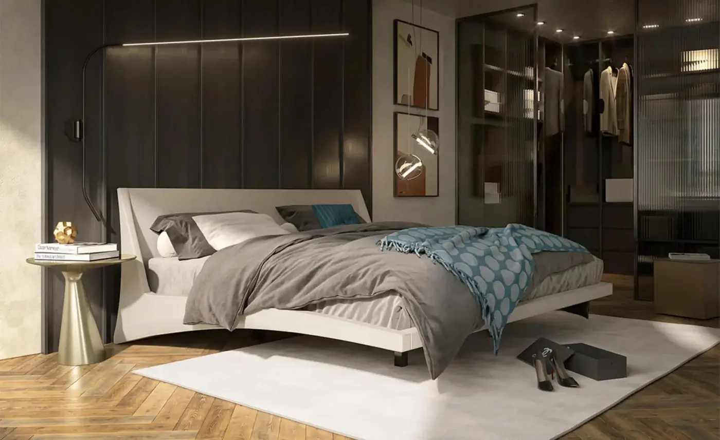 Cattelan Italia Dylan bed, light gray upholstery, platform style with dark gray angled legs, paired with brass side table and parquet flooring.