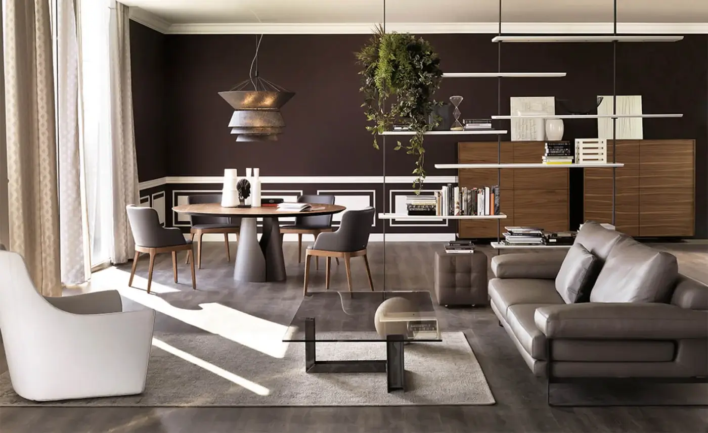 Giano dining table, dark wood veneer top, conical black base, surrounded by four wooden chairs, woven pendant light, walnut shelving.