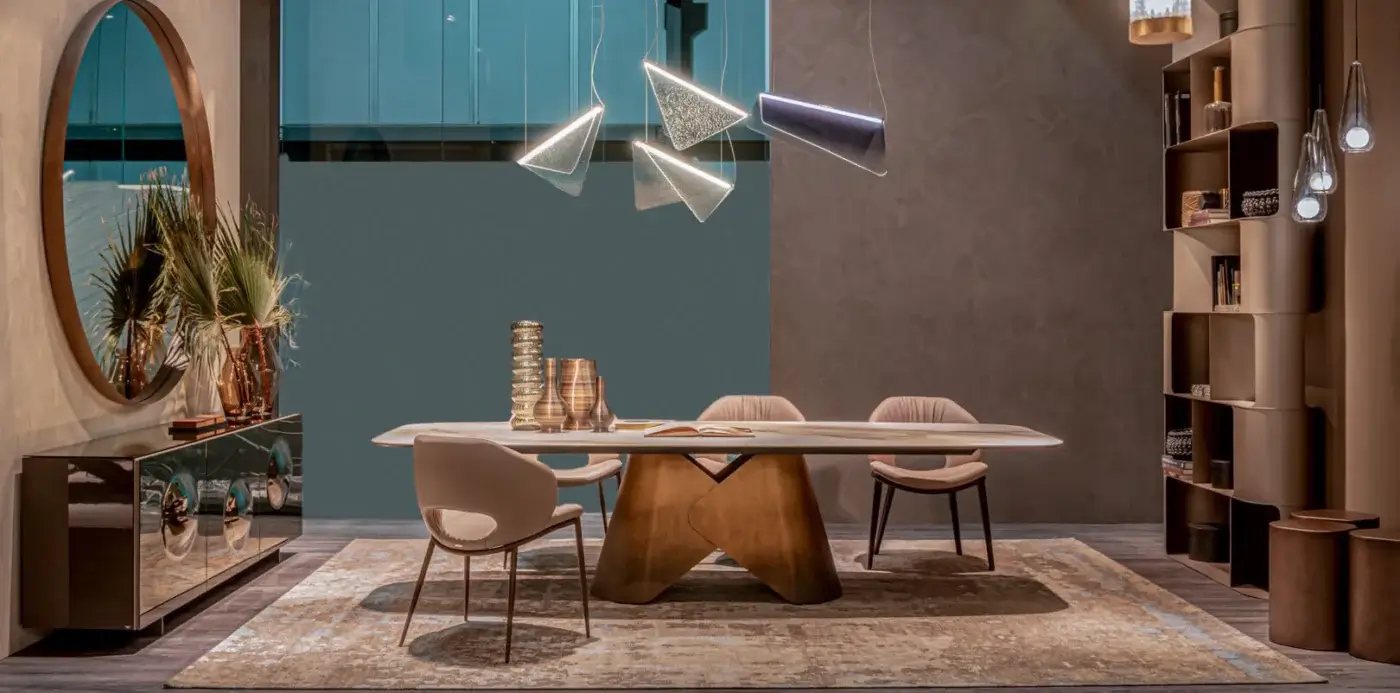 Cattelan Italia Scott table, ceramic tabletop, brushed brass base, paired with six beige fabric chairs, turquoise sideboard, and modern chandelier.