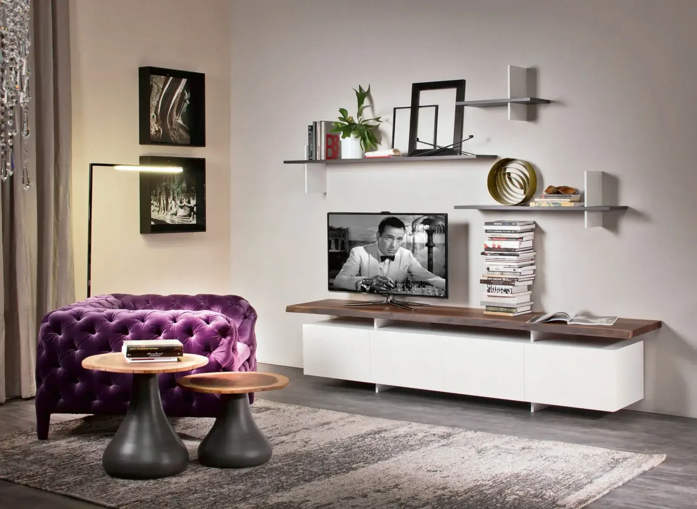 Cattelan Italia Seneca TV stand, white lacquered base, walnut top, modern living room with purple velvet armchair and shelving display.
