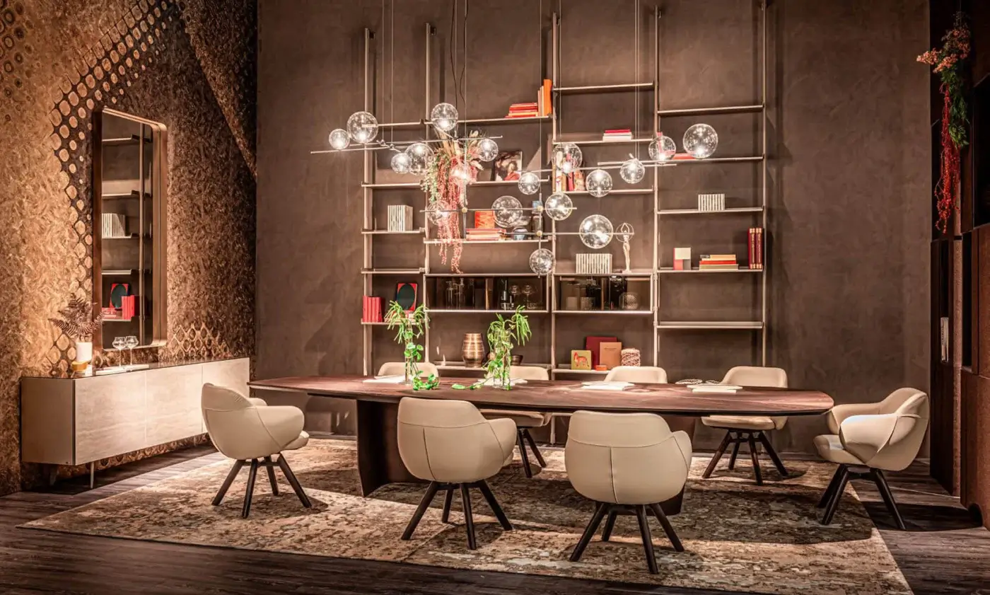 Cattelan Italia Senator dining table, dark wood oval, with eight light beige upholstered chairs, black metal legs, and spherical glass chandelier.
