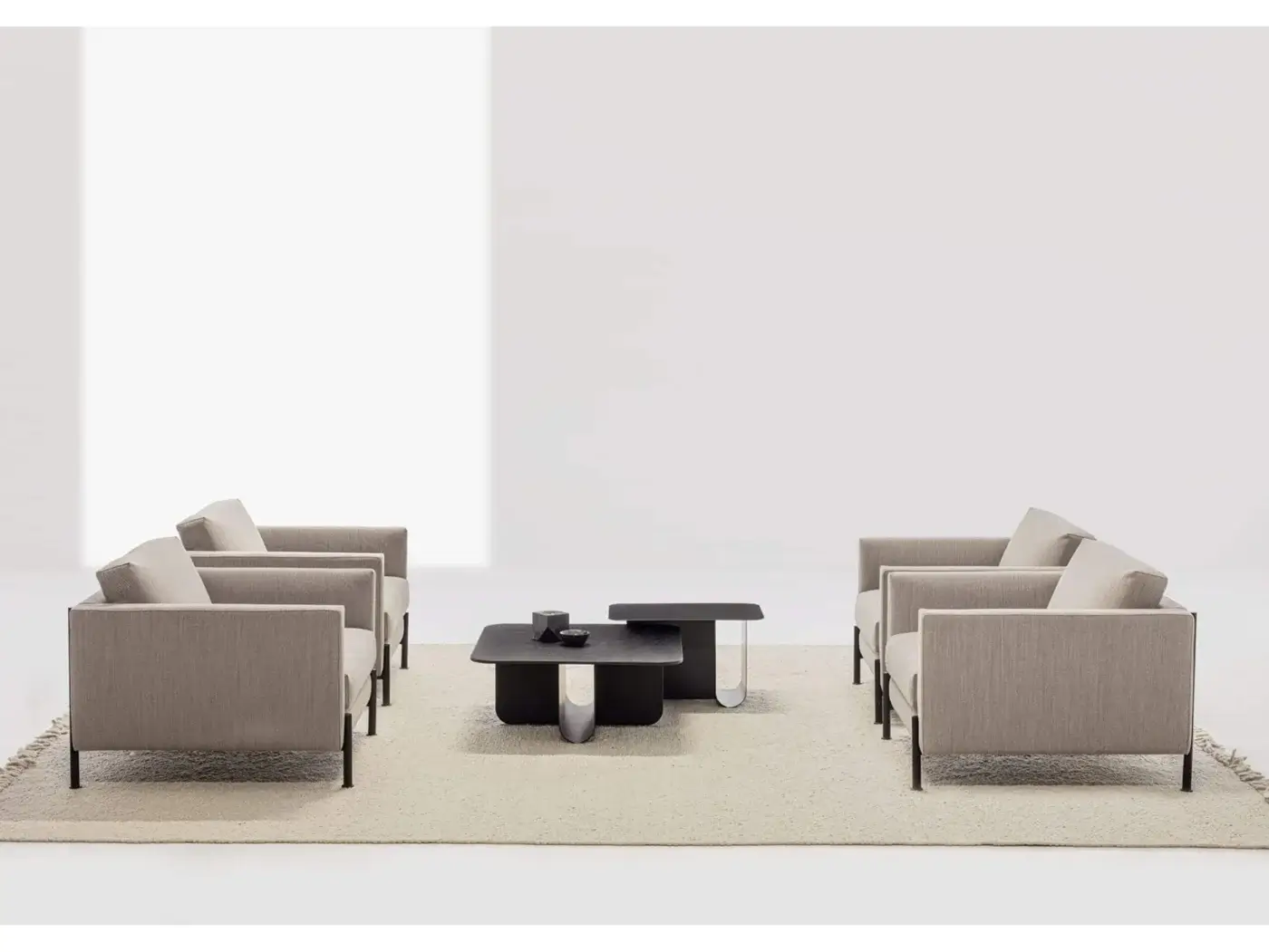 La Cividina lounge chairs, beige fabric, boxy design with black metal legs, and dark gray interlocking coffee table on textured rug.