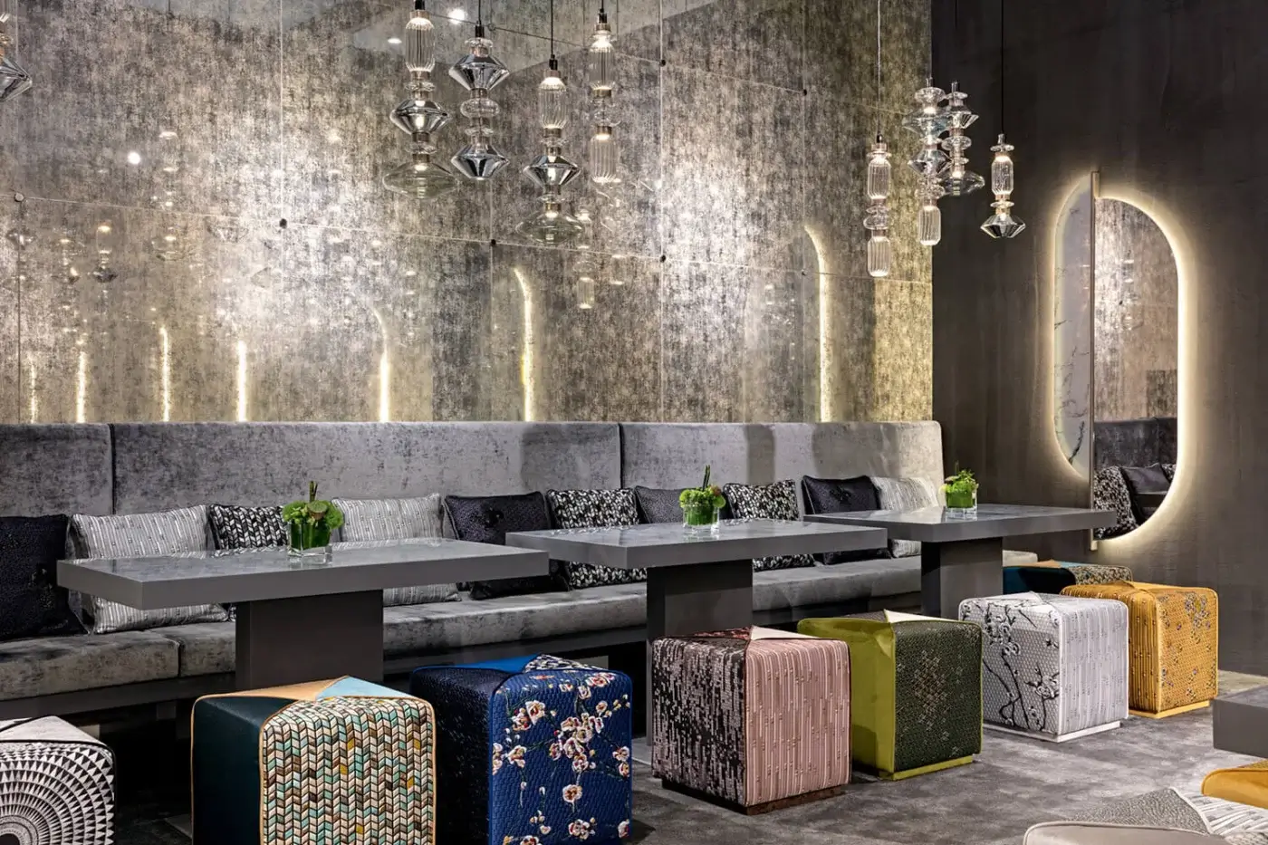 Superior Sicis Chamaleon square ottoman upholstered in multi-colored geometric fabric with a textured matte finish