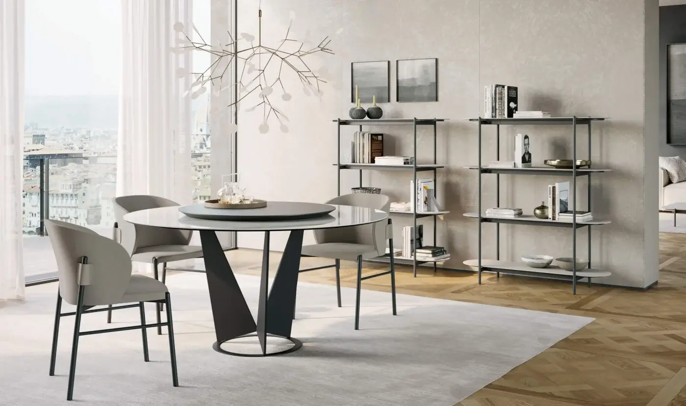Elegant Dallagnese Eiffel round table with smooth glass top and matte dark gray V-shaped metal base