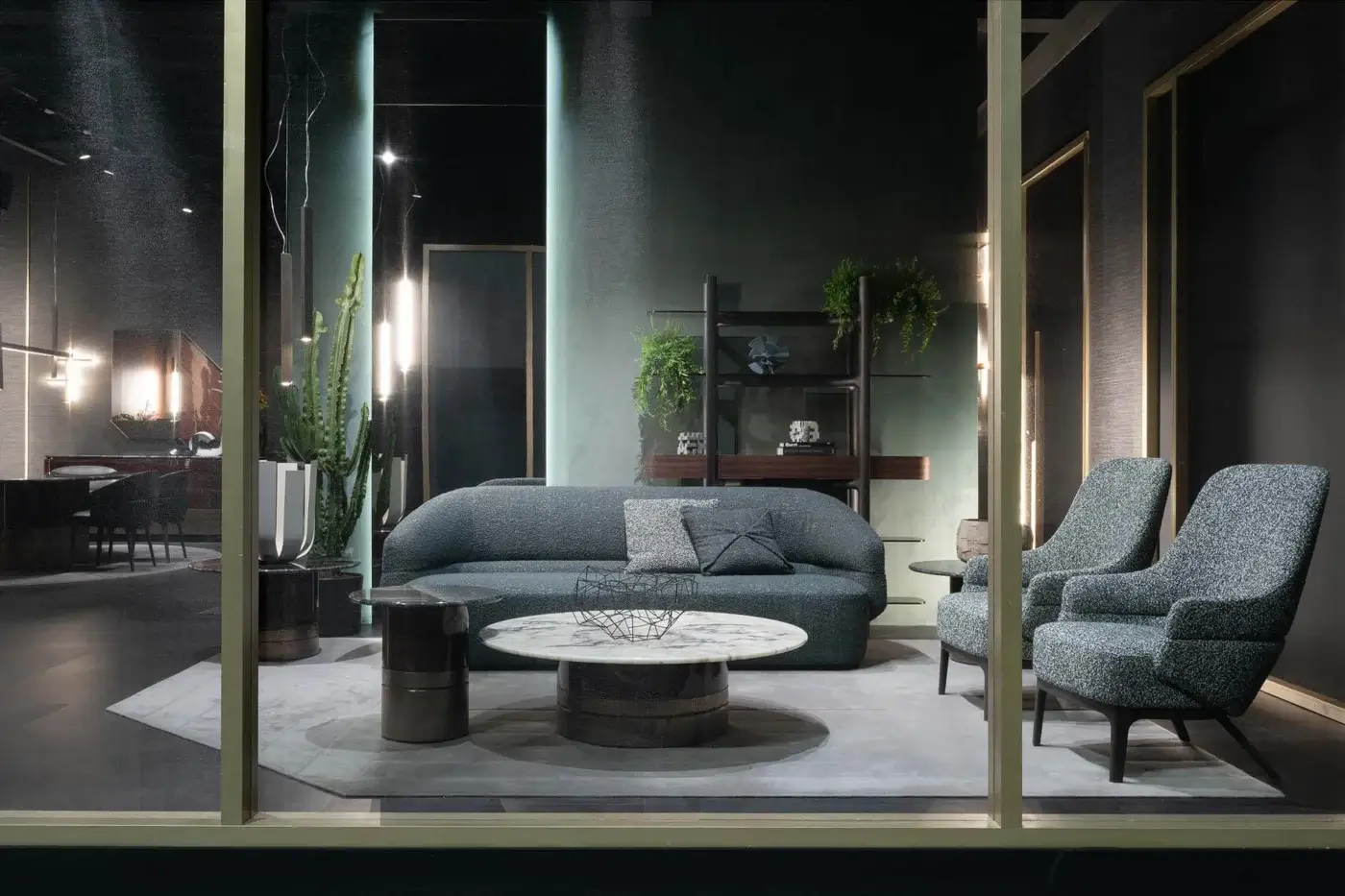 Elegant Zanaboni Alma sofa upholstered in subtly textured dark gray-blue textile with a refined grey stained ash wood base