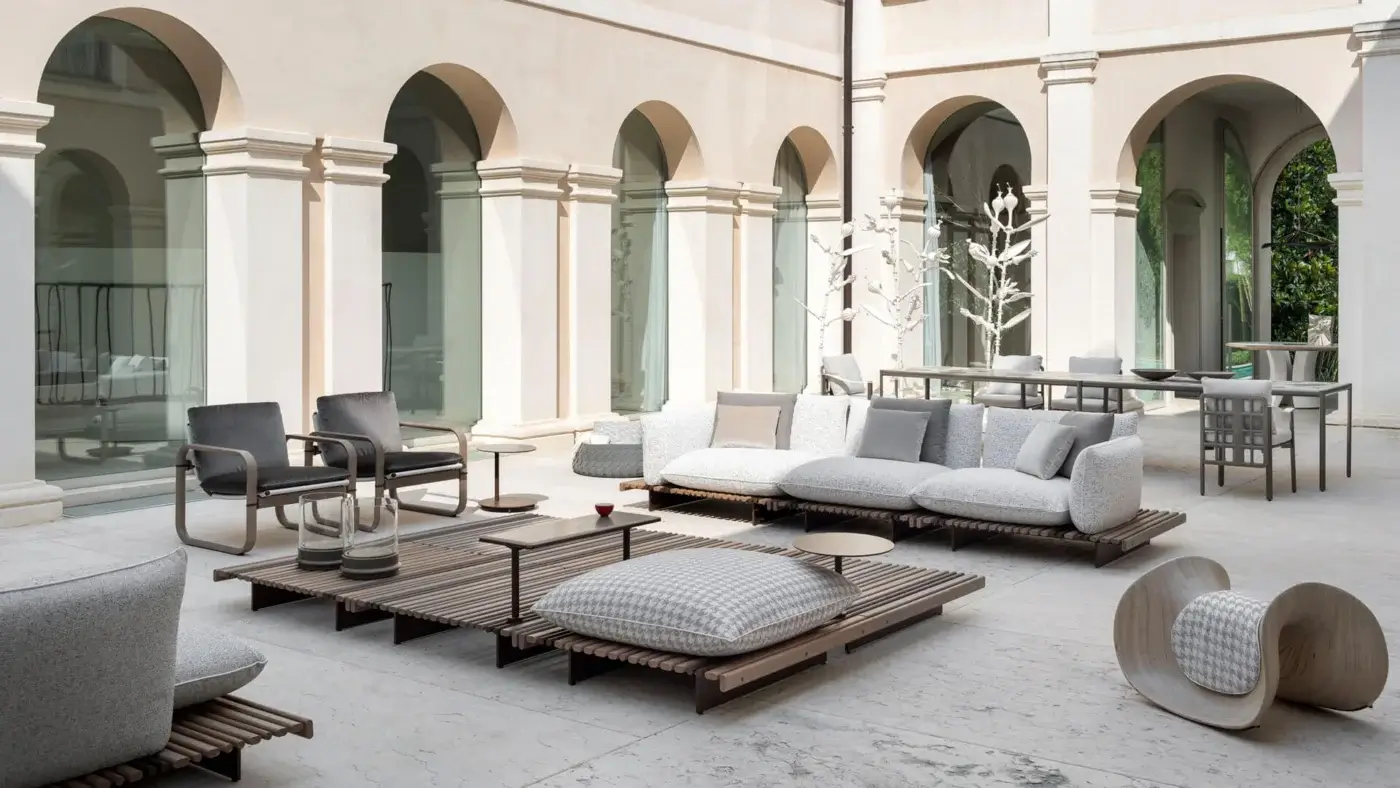Exceptional Giorgetti Aldìa armchair crafted with sleek metal and sculptural birch plywood in a satin finish with light gray waterproof fabric