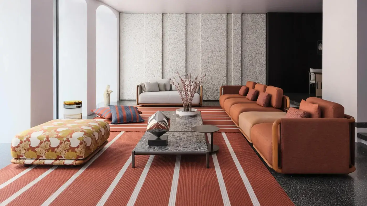 Distinguished Giorgetti Moorea ottoman with terracotta orange floral fabric upholstery and pewter painter stainless steel frame