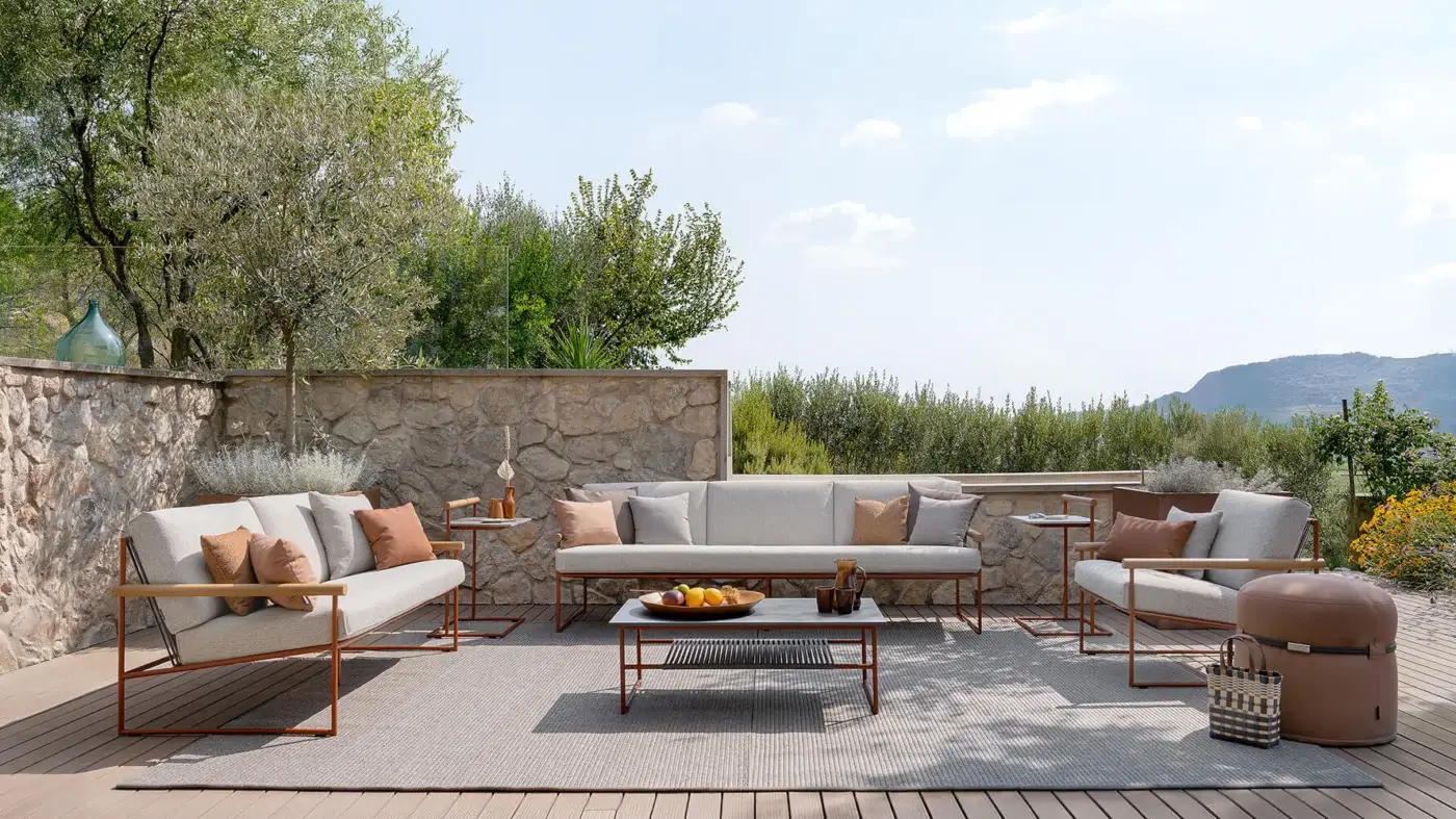 Superior Atmosphera Pipe lounge chair with terracotta epoxy-coated steel, woven acrylic cords and tactile teak armrests