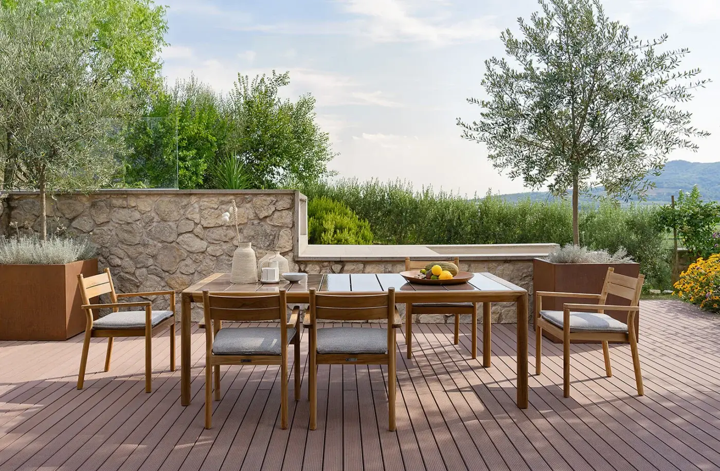 Elegant Atmosphera Panama armchair with warm brown timber frame and sleek gray textile built with a satin finish