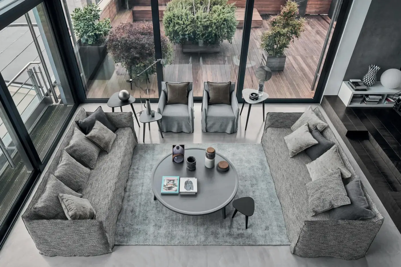 Sumptuous Gervasoni Ghost sofa in muted grey taupe textured textile with charcoal accent pillows and low profile silhouette