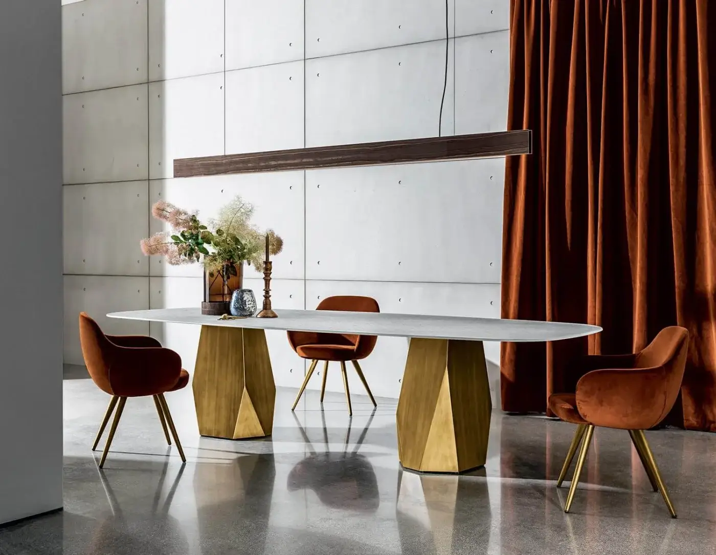 Distinguished Sovet Italia Deod table with a light gray ceramic laminated oval top and golden lacquered geometric metal bases