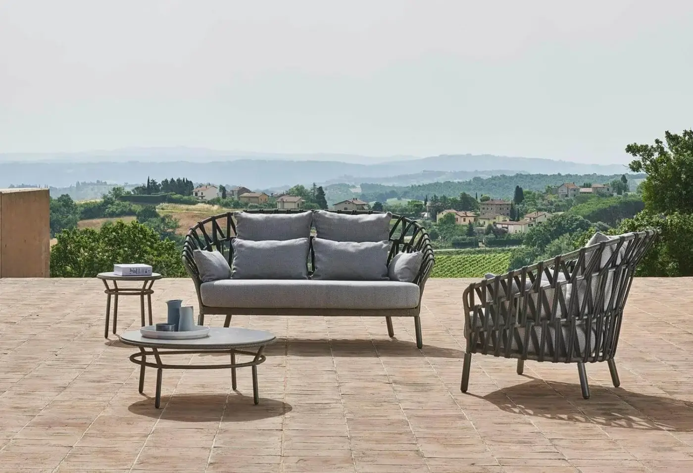 Elegant Varaschin Emma Cross sofa with dark woven fiber, light gray cushions and powder-coated aluminum frame