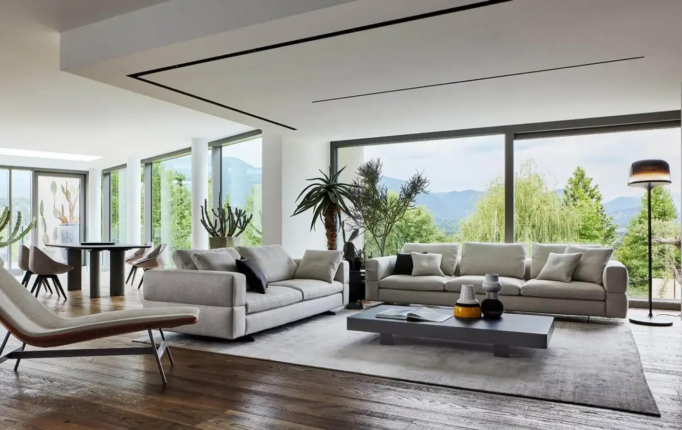 Sophisticated Bonaldo Ever More sofa with light grey matte textile upholstery and dark grey cushions built with sleek matt-painted metal feet