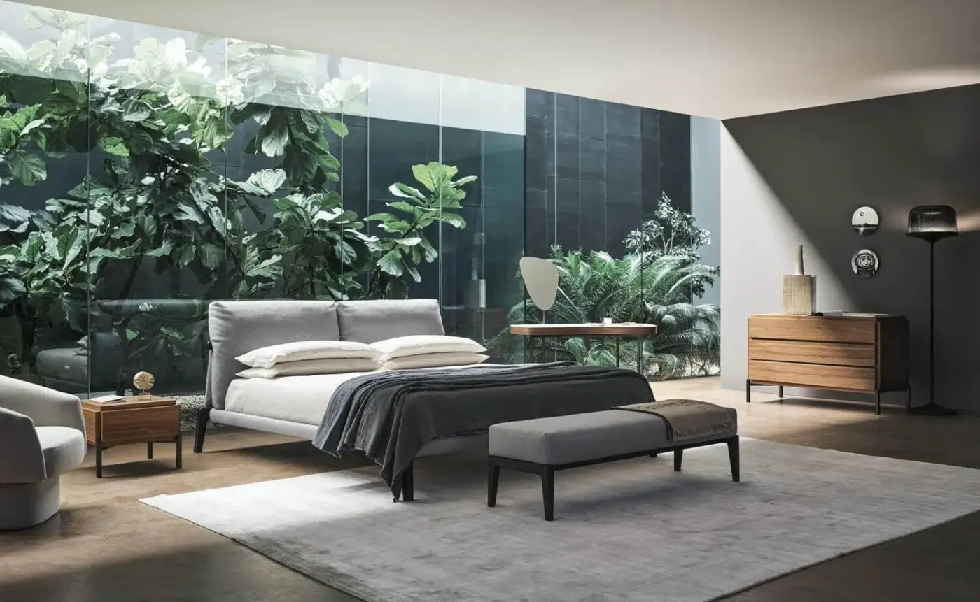 Exclusive Bonaldo Kriss bed with light grey textile headboard and frame built with dark-toned wooden legs