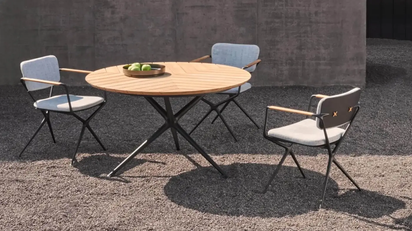 Exceptional Royal Botania Exes armchair with fluent cast aluminum frame in black and light gray textile upholstery with tapered teak armrests