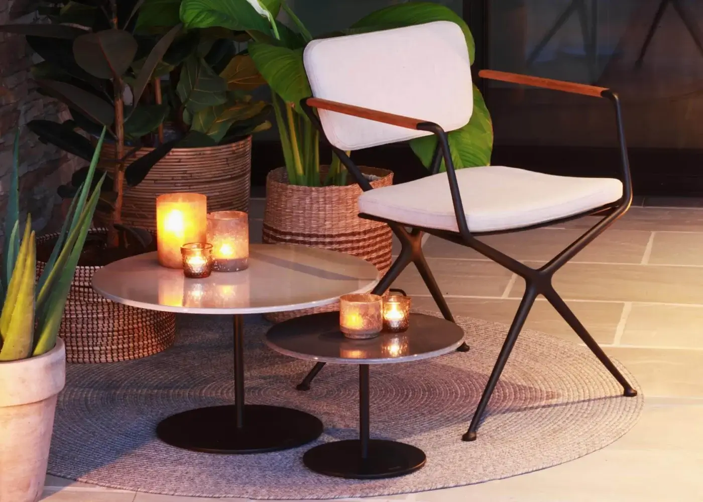 Distinguished Royal Botania Exes armchair with geometric dark metal frame and light upholstery built with tapered teak armrests