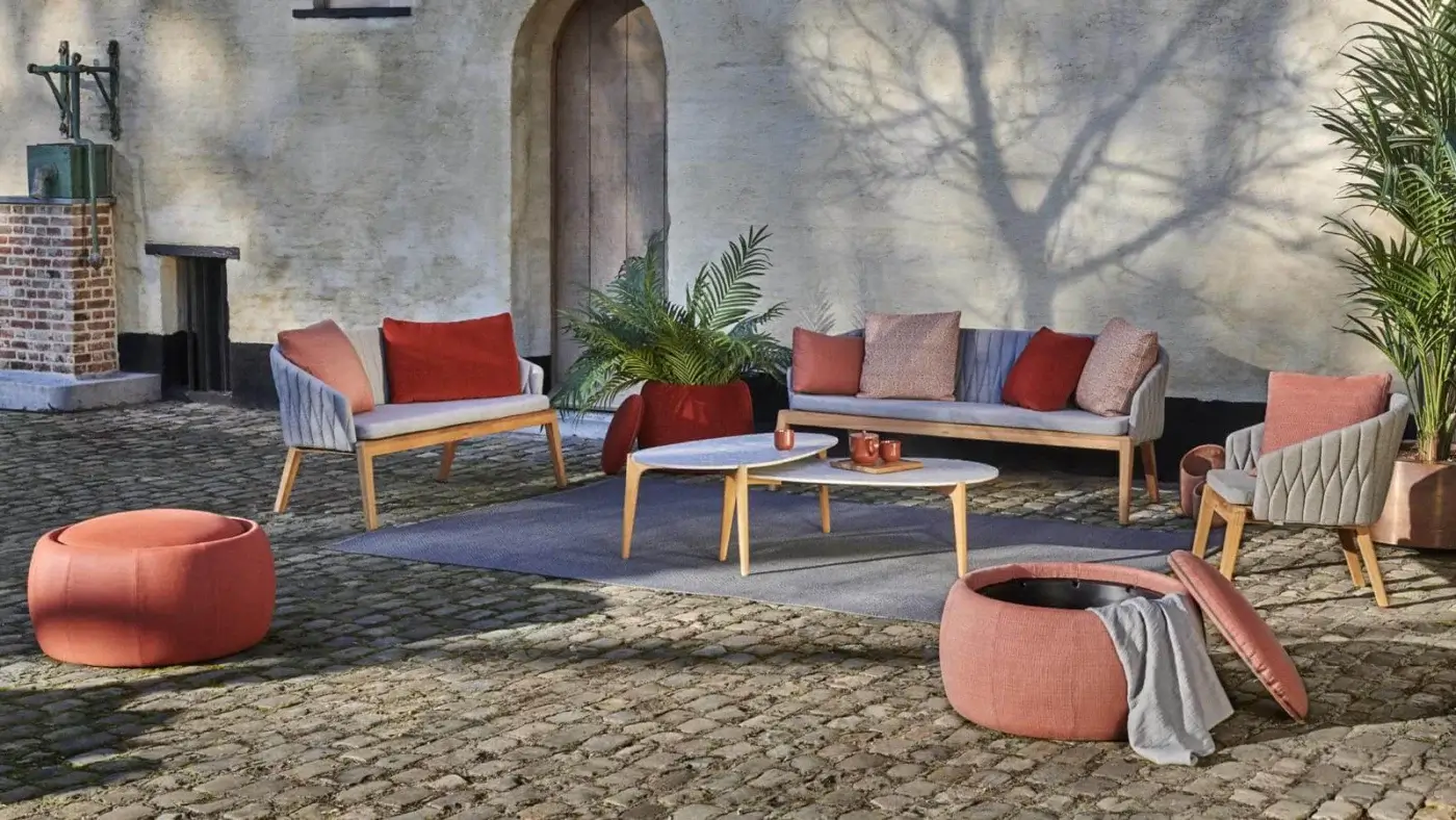 Distinguished Royal Botania Calypso Lounge ottoman built with teak and woven upholstery in a muted coral hue