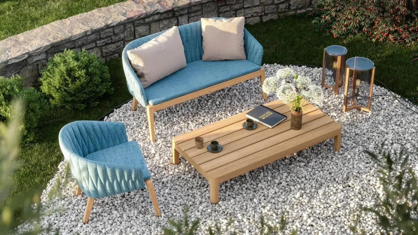 Elegant Royal Botania Calypso lounge chair with textured light blue textile upholstery and refined teak base