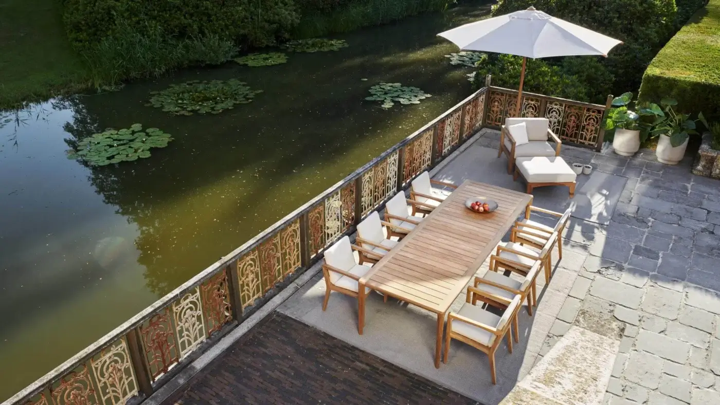 Exquisite Royal Botania U-nite table with slatted teak top and base exhibiting a light brown hue and natural wood grain