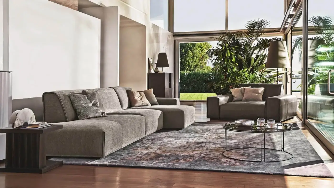 Stylish Ditre Italia Monolith lounge chair with wide armrests and thick seat cushion upholstered in medium gray textile with matte finish