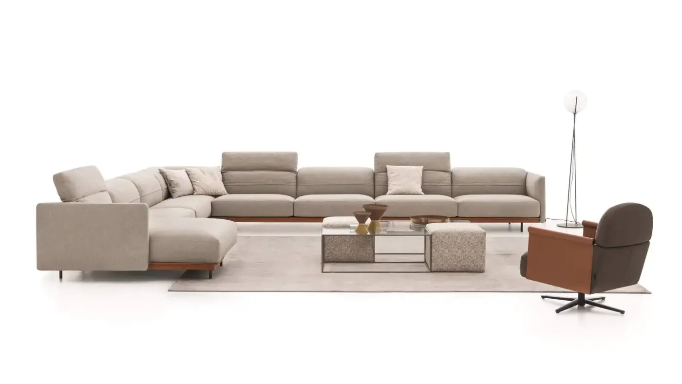 Distinguished Ditre Italia Beyl lounge chair with a rounded backrest and refined leather armrests in light beige textile with a sleek wooden base