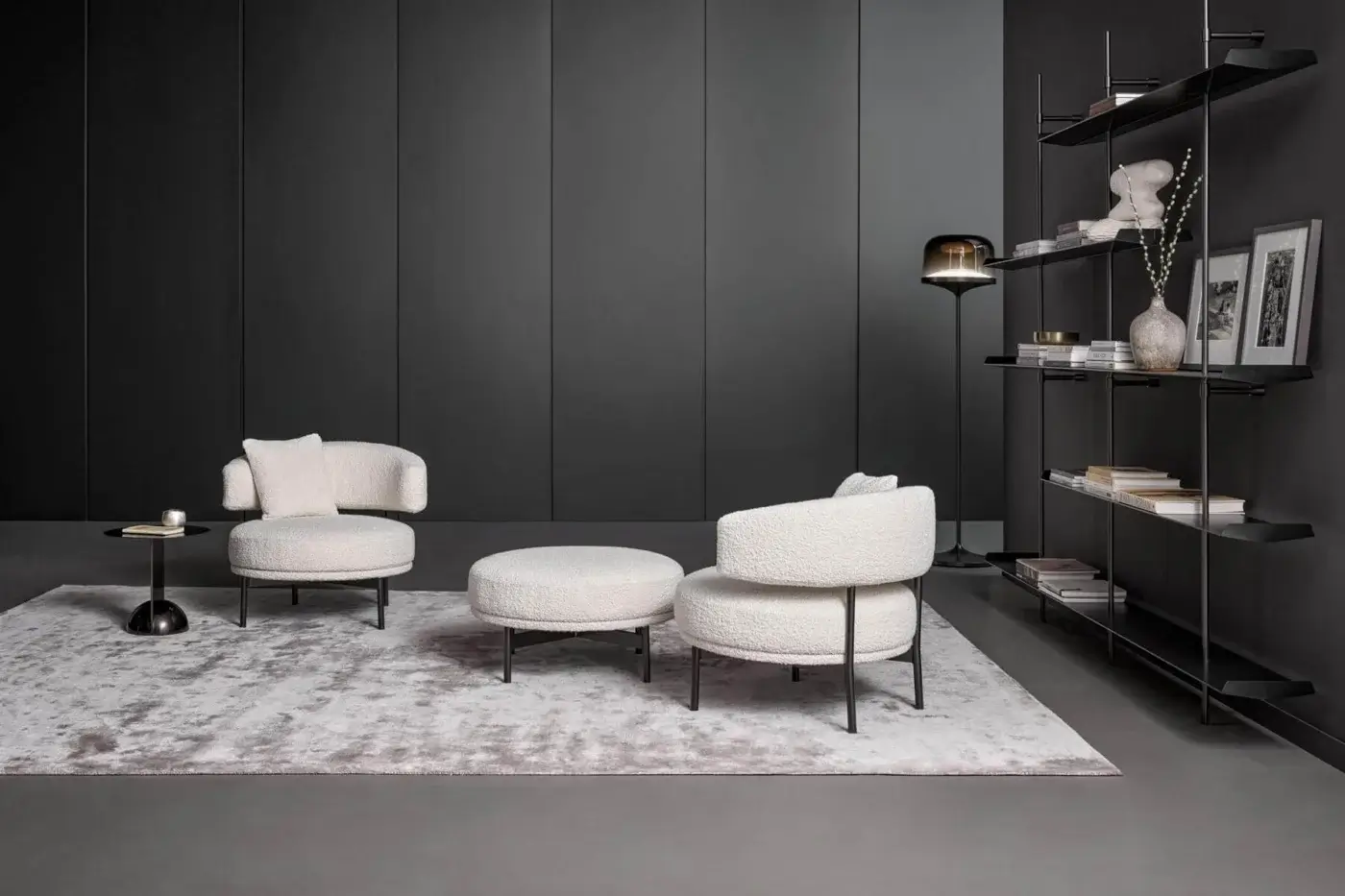 Lavish Bonaldo Neuilly lounge chair with rounded form upholstered in textured light cream fabric and dark matte metal frame