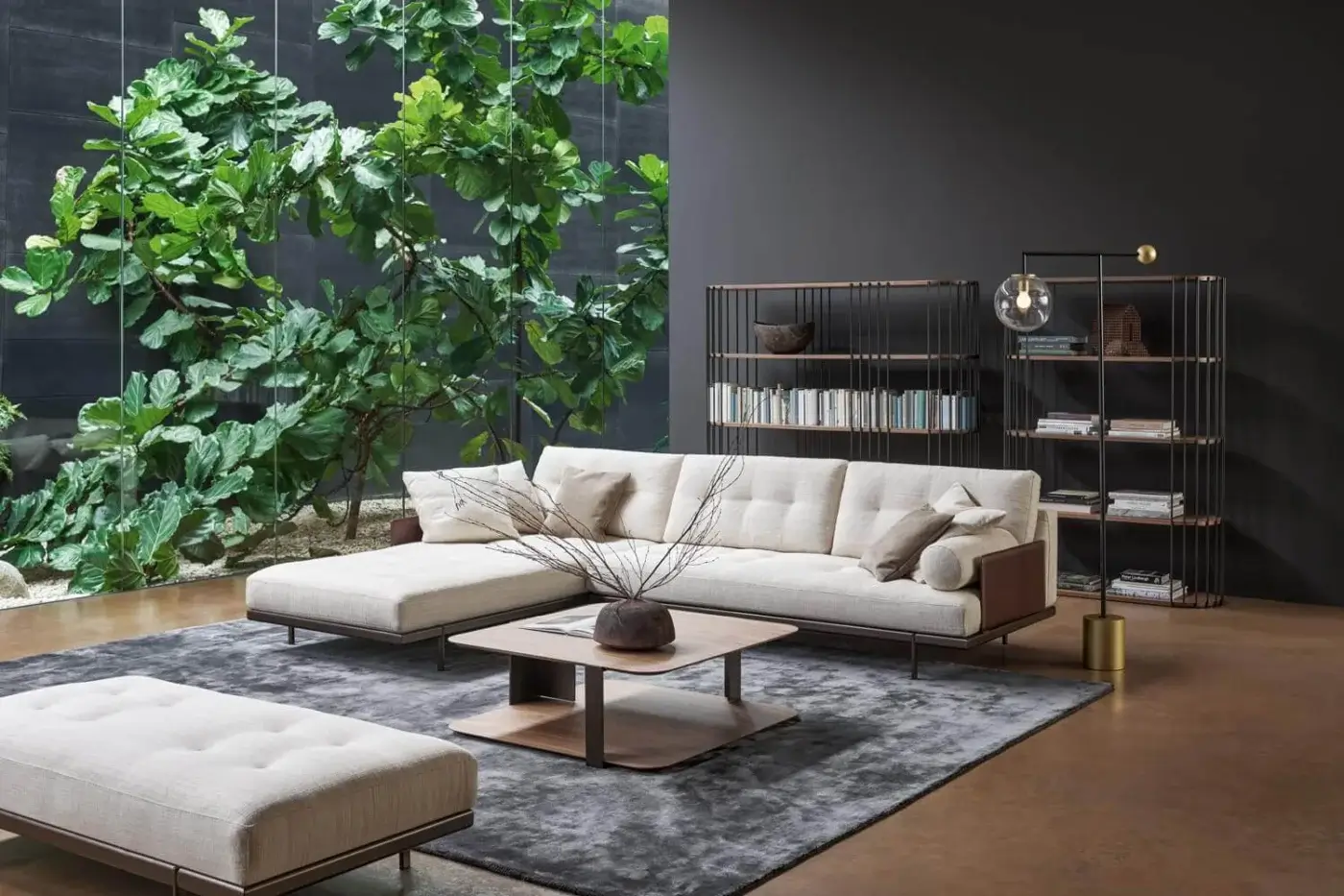 Bonaldo Maximilian sectional sofa, beige fabric upholstery, modular design with tufted ottoman, dark metal base, modern interior.
