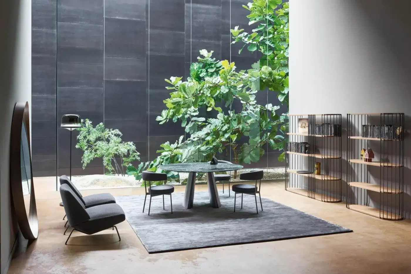 Refined Bonaldo Torii table with rigorous ceramic top and metal base exhibiting tonal variations in a cool gray matte finish