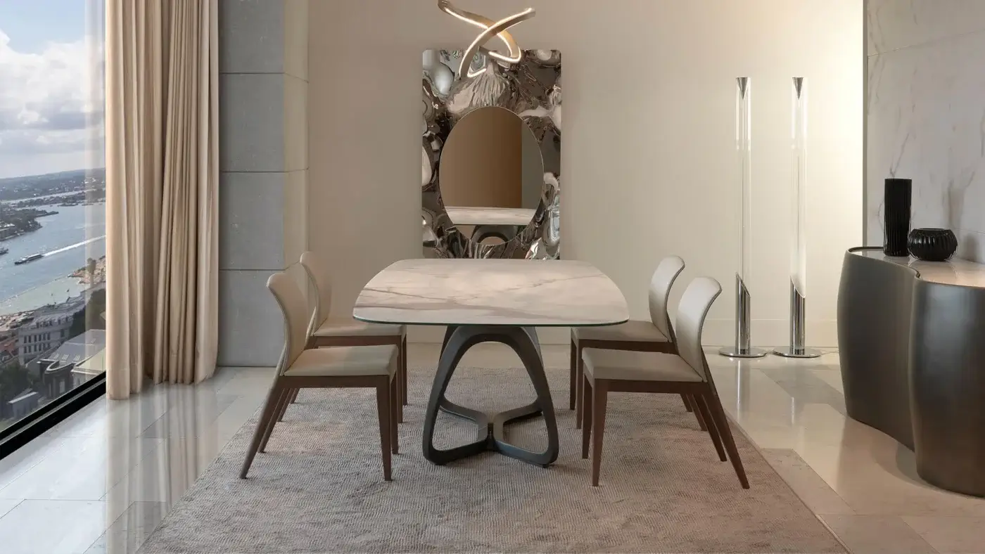 Luxury Reflex Segno table with a Marmoreflex top and dark brass composite material base crafted with curved supports