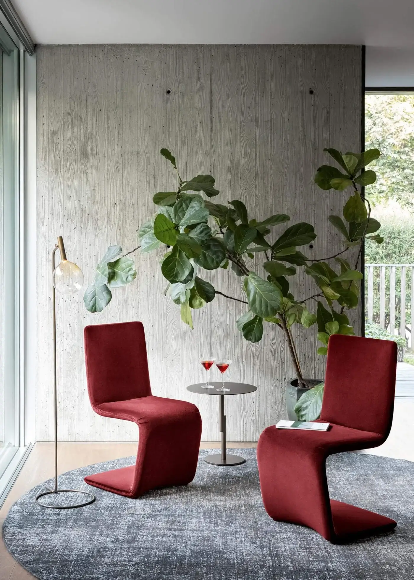 Elegant Bonaldo Venere chair with curved lines and fully upholstered form in deep red textile with matte finish