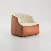 Blob lounge chair bi-tone, reddish-brown leather exterior, cream fabric interior, rounded molded form, low wide base, visible stitching.