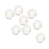 Clear glass sphere pendant lights, warm glow, minimalist cluster arrangement against a white backdrop.