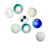 Glass beads in clear, pale blue, teal, and royal blue tones display circular inclusions, arranged overlapping on a white background.