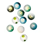 Spherical wall lights, translucent glass, assorted blue, green, gray, olive hues, asymmetrical cluster, circular openings, warm glowing light.