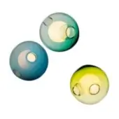 Spherical wall lights, blown glass, teal, blue, and yellow-green gradient, circular openings, warm glow, minimalist modern design.