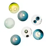Glass spheres in yellow-green, blue, and white with circular openings are arranged on a white background in a dynamic, overlapping composition.
