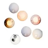Seven spherical pendant lights in lavender, peach, amber, pink, gray-accented glass, and cream, each with circular openings and warm illumination.