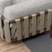 Sofa backrest, light gray textured fabric, dark brown wood frame with beige woven crisscross belts, studio setting.