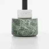 Lamp base, green marble and white stone, stacked cylindrical form with central dark rod and polished reflective surface.