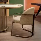 Superior Vismara Bell armchair with curved form upholstered in light beige textured fabric and matte fumè metal structure