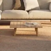 Luxury Royal Botania Mambo Lounge coffee table in teak wood, designed with a slatted tabletop supported by cylindrical legs, showcasing a natural finish.