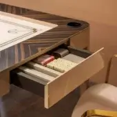 Multigame table with dark brown wood veneer, striped grain, circular cutout, blue graphic, gray drawer holding cards and bone pieces, gold legs.