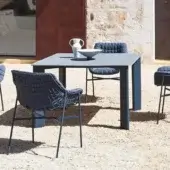 Distinguished Varaschin Plinto table with square HPL top and dark blue powder coated aluminum legs