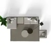 Beige L-shaped sofa with white pillows, dark wood & gray stone coffee tables, black floor lamp, and green plant on neutral rug.