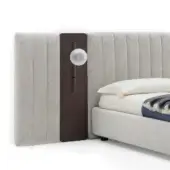Upholstered headboard with walnut panel and brushed metal light fixture, beige fabric, vertical pleating, studio shot.