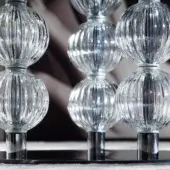 Floor lamps, Murano glass, stacked globes with vertical ribbing and chrome connectors on cylindrical bases, reflective black surface.
