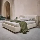 Elegant Ditre Italia Claire bed with textured light beige textile upholstery and curved wraparound headboard